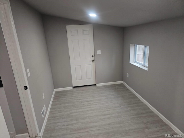 foyer entrance featuring recessed lighting, baseboards, and light wood finished floors