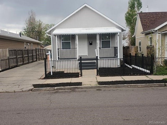 view of front of house with covered porch and a fenced front yard