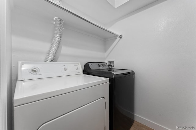 laundry area with washer and dryer and hardwood / wood-style floors