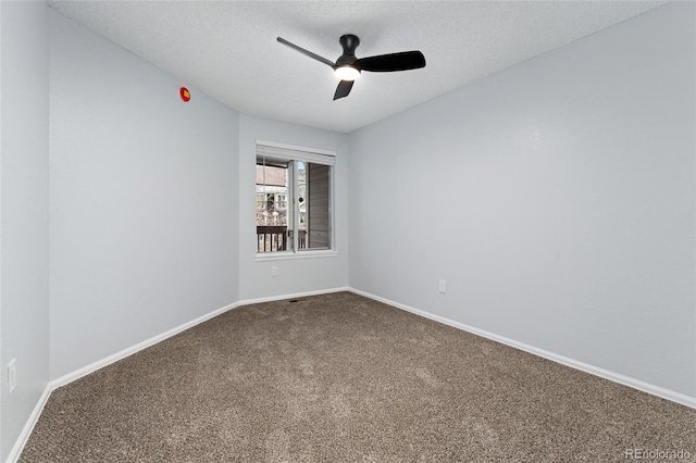 empty room featuring carpet floors, ceiling fan, and a textured ceiling