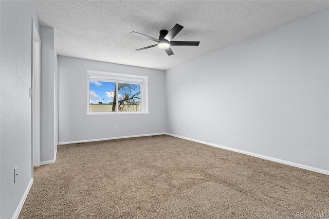 empty room featuring ceiling fan, a textured ceiling, and carpet flooring