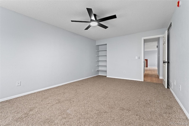 unfurnished bedroom with ceiling fan, carpet, and a textured ceiling