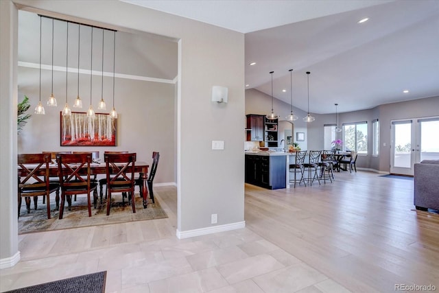 dining space featuring french doors and vaulted ceiling