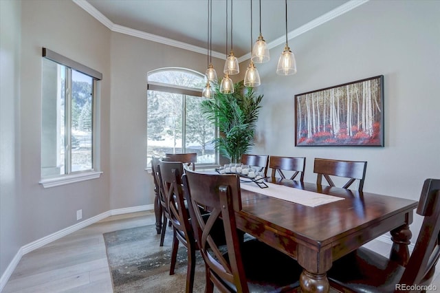 dining space featuring hardwood / wood-style flooring and ornamental molding