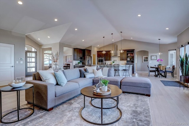 living room with lofted ceiling and light wood-type flooring