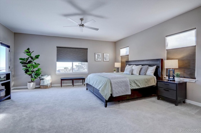 carpeted bedroom with ceiling fan and multiple windows