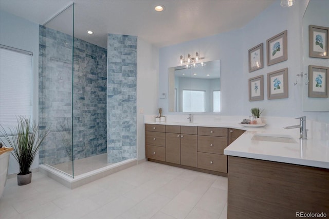 bathroom with vanity, tile patterned floors, and tiled shower