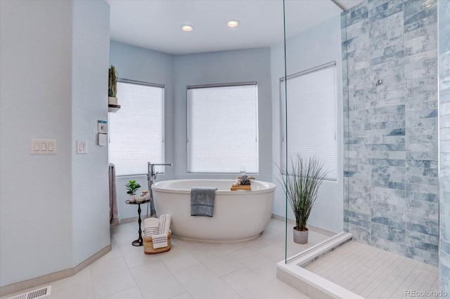 bathroom with separate shower and tub and tile patterned floors