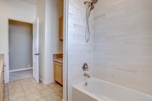 bathroom featuring tiled shower / bath and vanity