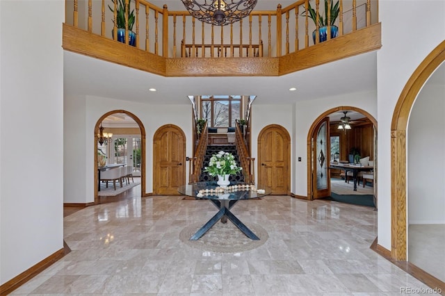 5 Tamarade Dr, Littleton, CO 80127 - entrance foyer featuring baseboards, arched walkways, and a high ceiling