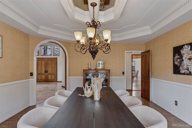 5 Tamarade Dr, Littleton, CO 80127 - dining room with a raised ceiling, arched walkways, wainscoting, wood finished floors, and wallpapered walls