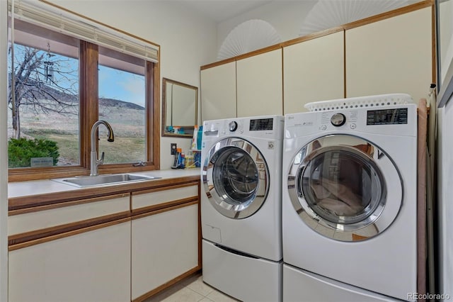 5 Tamarade Dr, Littleton, CO 80127 - washroom featuring light tile patterned flooring, washing machine and dryer, a sink, and cabinet space