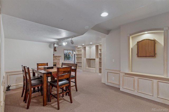 5 Tamarade Dr, Littleton, CO 80127 - dining room with track lighting, a decorative wall, light colored carpet, and wainscoting