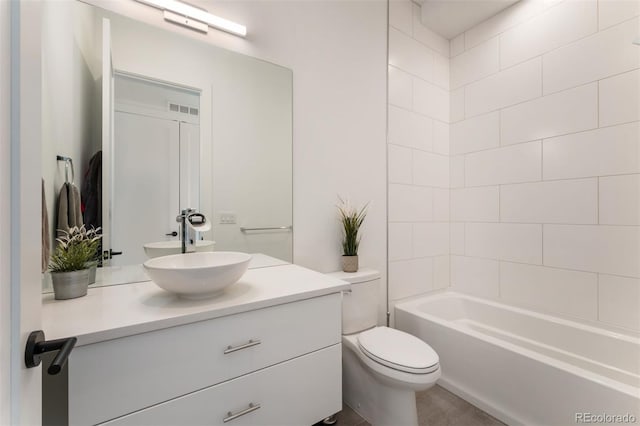 bathroom featuring visible vents, shower / bathing tub combination, vanity, and toilet