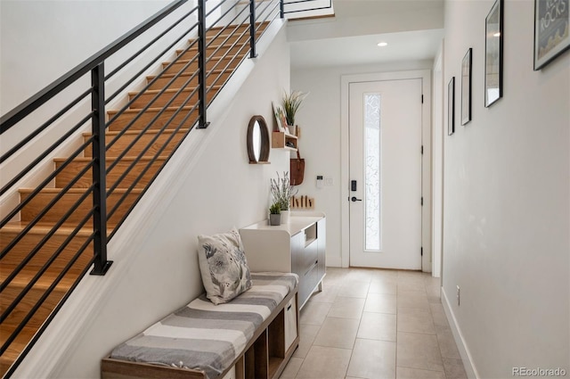 foyer with stairs, recessed lighting, baseboards, and light tile patterned floors