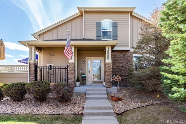 4712 Raven Run, Broomfield, CO 80023 - view of front of property featuring board and batten siding, a porch, and stone siding