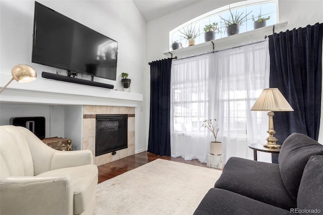 4712 Raven Run, Broomfield, CO 80023 - living room with a fireplace, wood finished floors, and a wealth of natural light