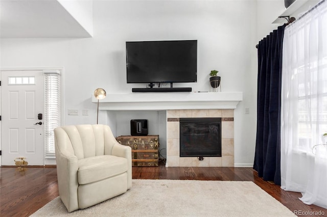4712 Raven Run, Broomfield, CO 80023 - living area featuring wood finished floors, baseboards, and a fireplace