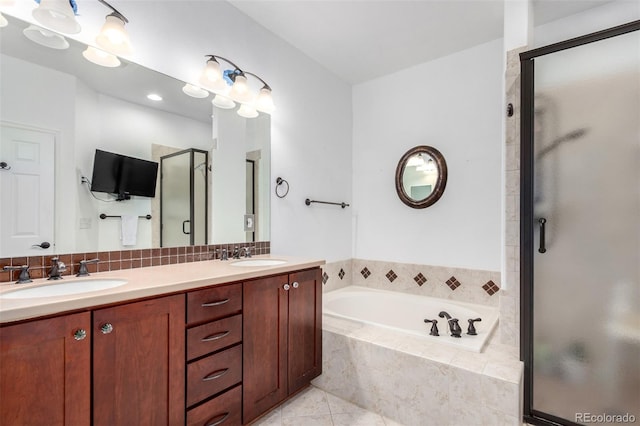 4712 Raven Run, Broomfield, CO 80023 - full bathroom featuring double vanity, a shower stall, a garden tub, and a sink