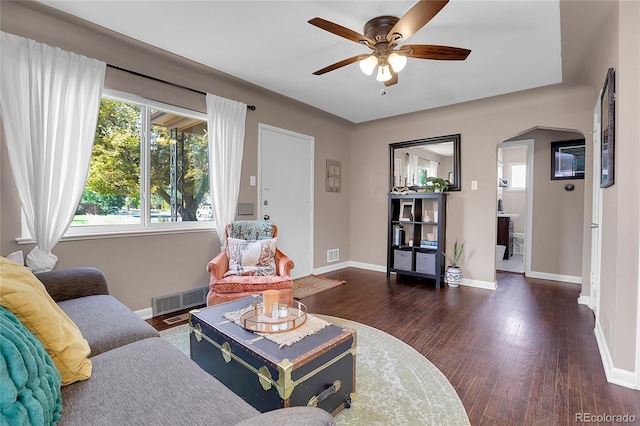 living room with ceiling fan and dark hardwood / wood-style floors