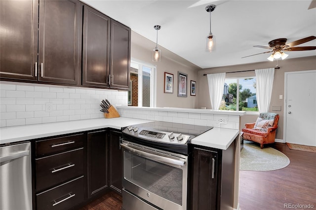 kitchen with stainless steel appliances, kitchen peninsula, ceiling fan, and dark hardwood / wood-style flooring