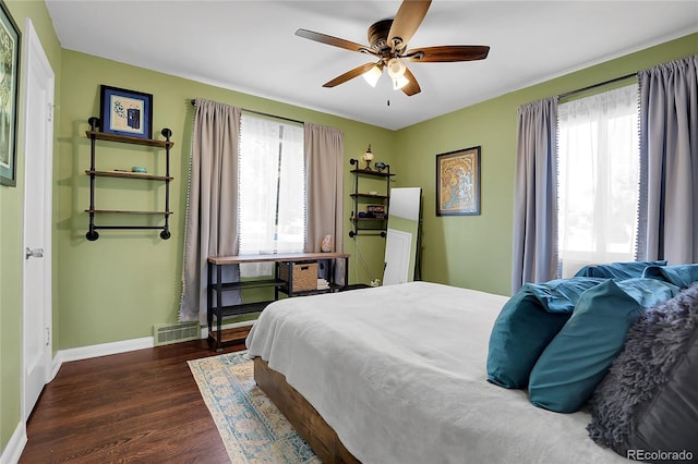 bedroom with ceiling fan and dark wood-type flooring