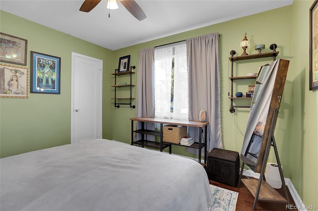 bedroom featuring dark hardwood / wood-style floors and ceiling fan