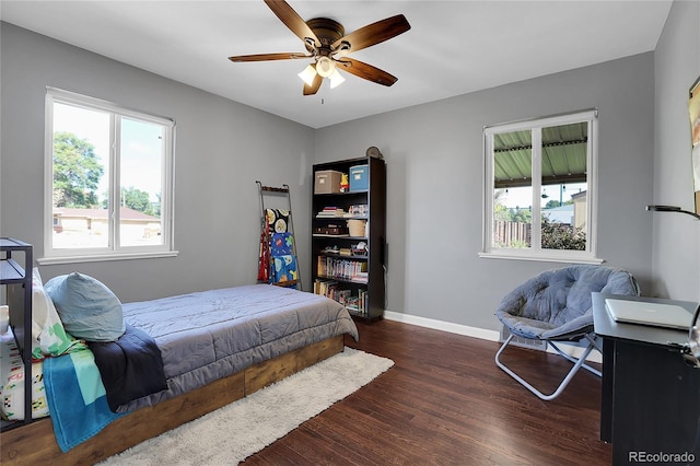 bedroom with dark hardwood / wood-style floors and ceiling fan