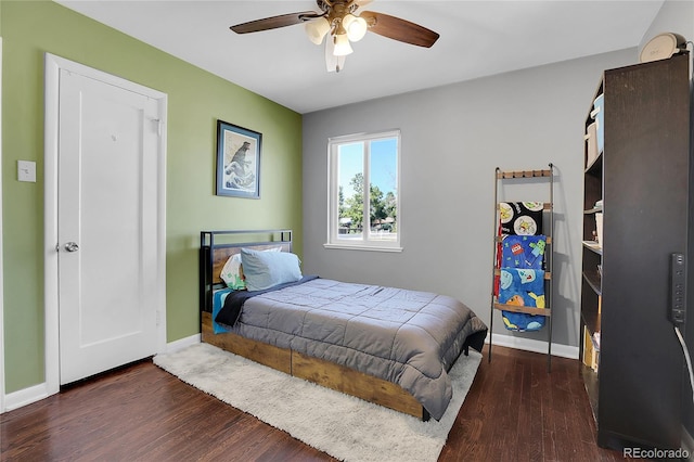 bedroom featuring ceiling fan and dark wood-type flooring