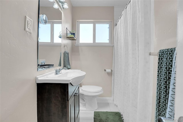 bathroom featuring curtained shower, vanity, toilet, and tile patterned floors