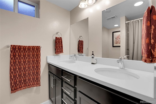 bathroom featuring vanity and curtained shower