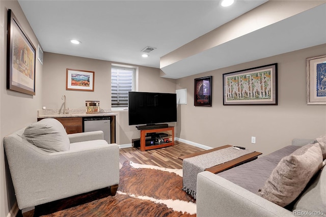 living room with hardwood / wood-style floors and wet bar