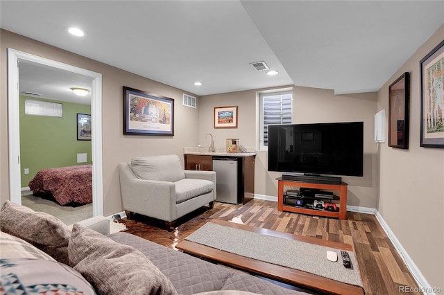 living room with wet bar and light wood-type flooring