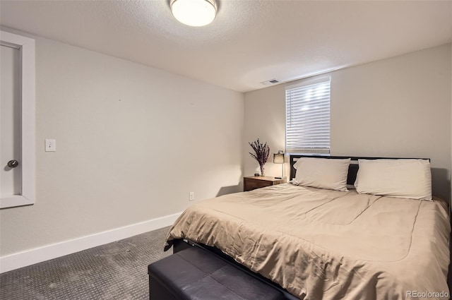 carpeted bedroom featuring a textured ceiling