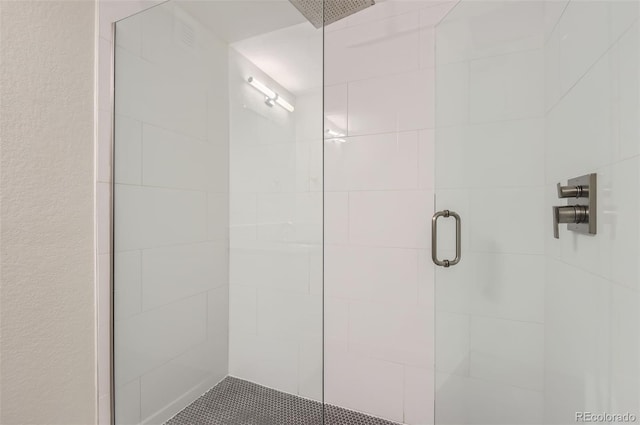 bathroom with a shower with door