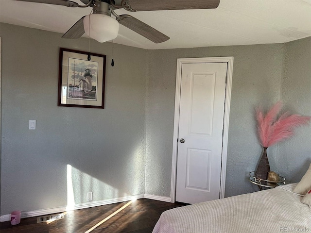 bedroom with dark wood-type flooring and ceiling fan