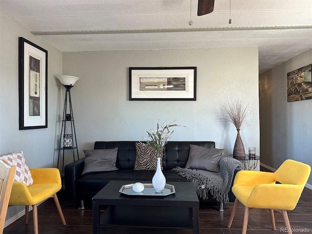 living room with dark hardwood / wood-style flooring and ceiling fan