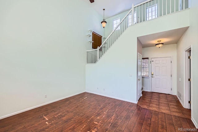 entrance foyer with dark hardwood / wood-style flooring and a high ceiling