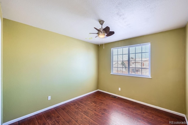 unfurnished room featuring ceiling fan, dark hardwood / wood-style flooring, and a textured ceiling