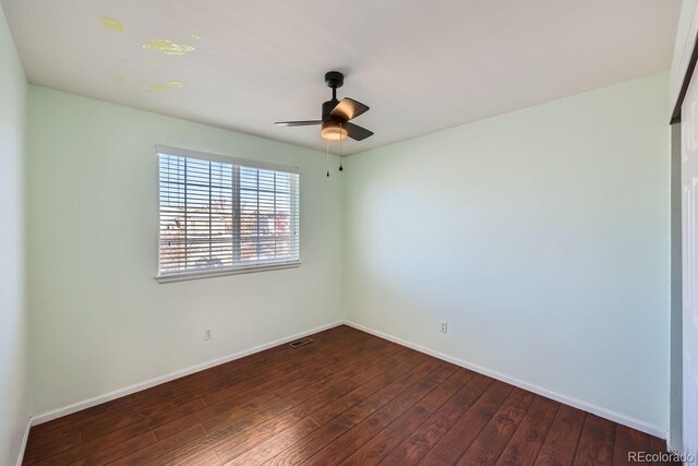 unfurnished room featuring ceiling fan and dark hardwood / wood-style floors