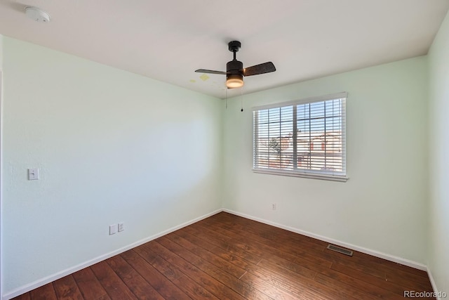 empty room featuring dark hardwood / wood-style flooring and ceiling fan