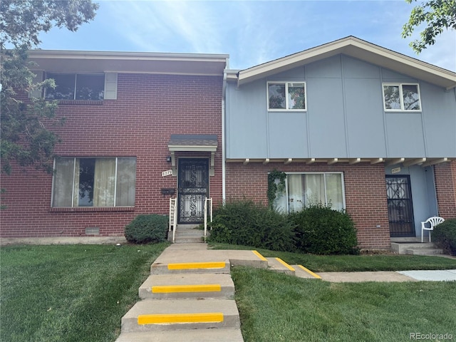 8779 Santa Fe Dr, Thornton, CO 80260 - townhome / multi-family property with brick siding and a front lawn