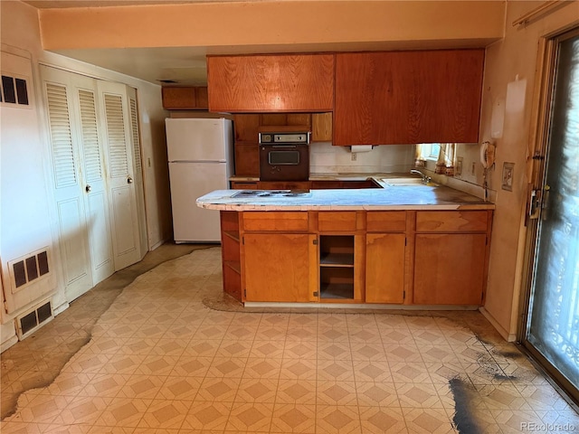 8779 Santa Fe Dr, Thornton, CO 80260 - kitchen with freestanding refrigerator, oven, open shelves, light countertops, and light flooring