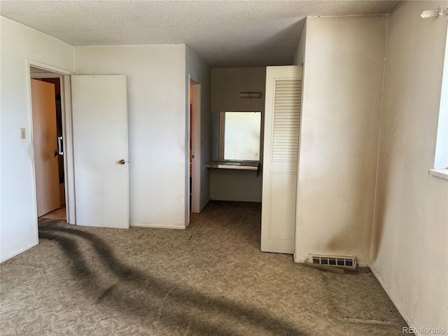 8779 Santa Fe Dr, Thornton, CO 80260 - unfurnished bedroom featuring carpet and a textured ceiling