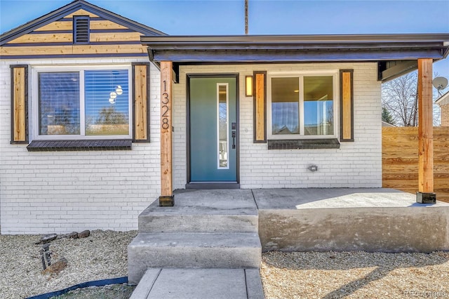 doorway to property with brick siding