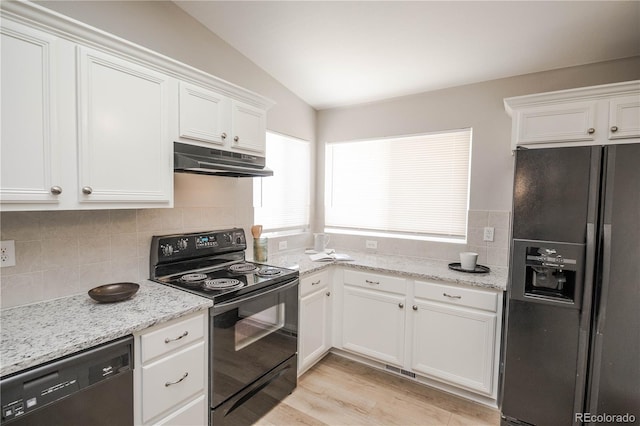 kitchen featuring lofted ceiling, under cabinet range hood, white cabinets, backsplash, and black appliances