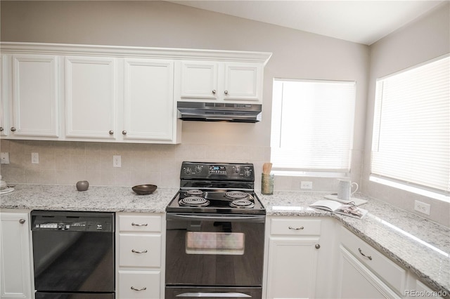 kitchen with under cabinet range hood, white cabinets, vaulted ceiling, light stone countertops, and black appliances