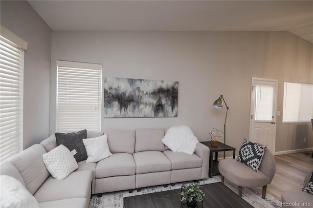 living room with vaulted ceiling and wood finished floors