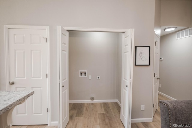 laundry area featuring hookup for an electric dryer, laundry area, washer hookup, visible vents, and light wood-style floors