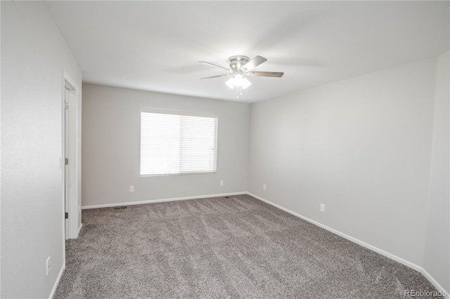 empty room featuring carpet floors, baseboards, and a ceiling fan